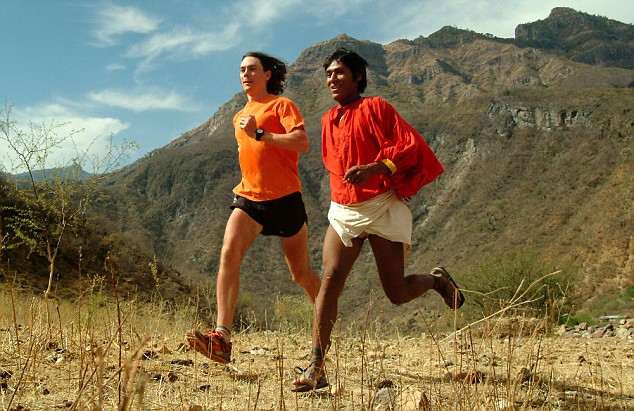Tarahumara runner Arnulfo Quimare runs alongside ultra-runner Scott Jurek in Mexico's Copper Canyons